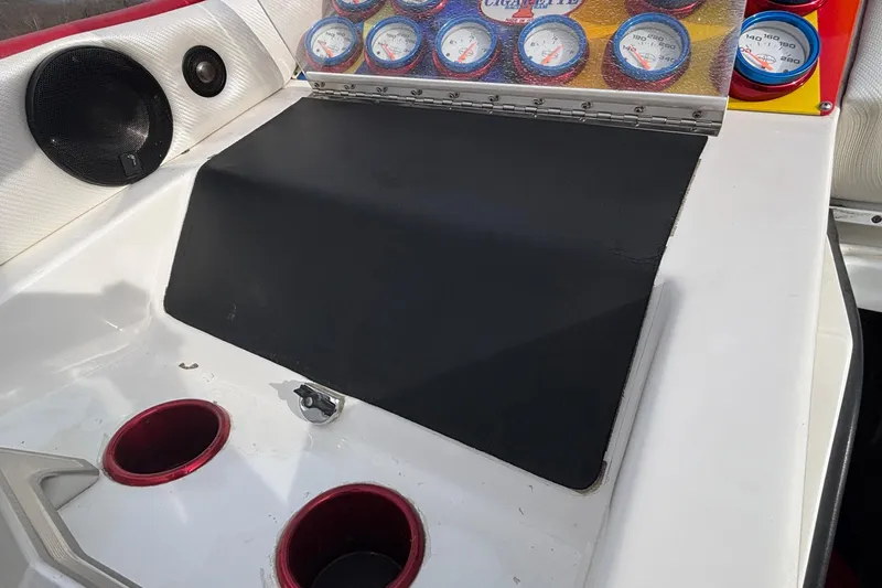 Slide: The Image of 2003 Cigarette 38' Top Gun dashboard with gauges and cup holders. - 19