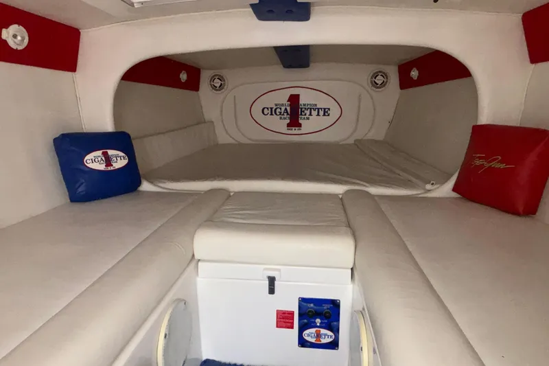 Slide: The Image of Interior of a 2003 Cigarette 38' Top Gun boat with branded cushions and sleek design. - 22