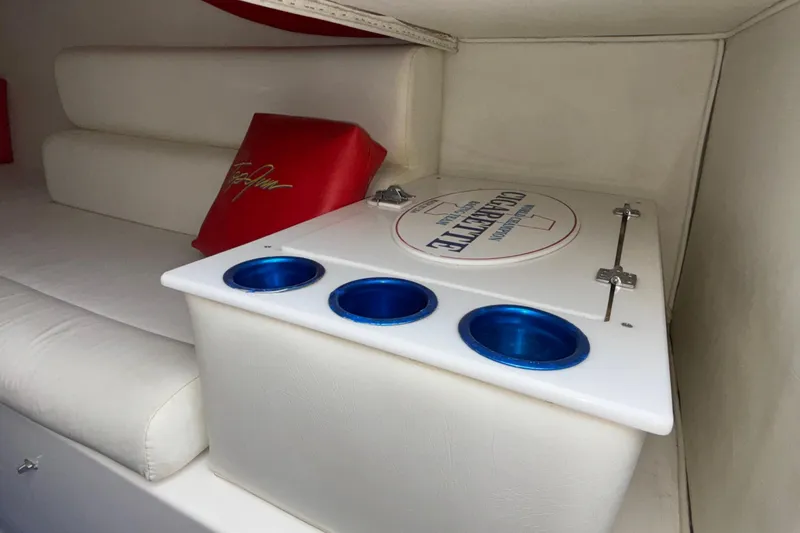 Slide: The Image of 2003 Cigarette 38' Top Gun boat interior with white seating and blue cup holders. - 23