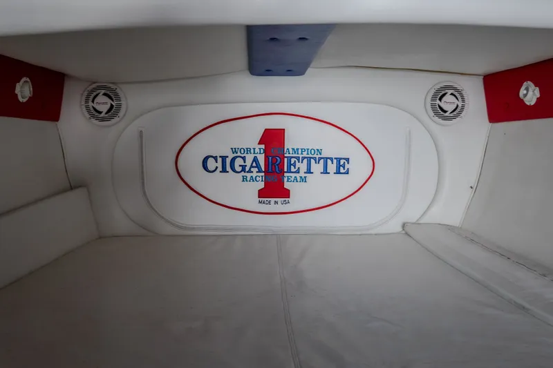 Slide: The Image of Interior of a 2003 Cigarette 38' Top Gun boat, featuring branded racing team logo. - 23