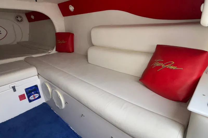 Slide: The Image of Interior of 2003 Cigarette 38' Top Gun boat with white seating and red accents. - 24