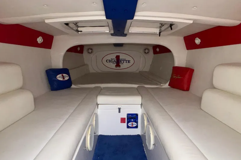 Slide: The Image of Interior of 2003 Cigarette 38' Top Gun boat with white seating and red accents. - 25