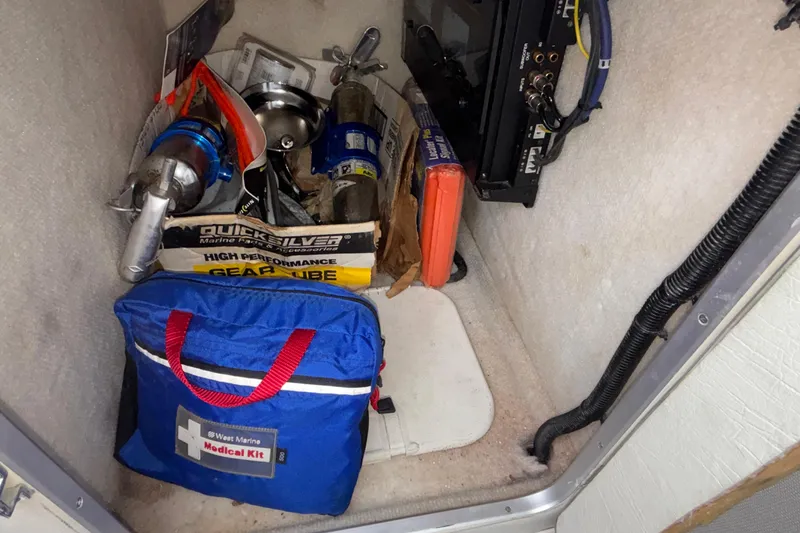 Slide: The Image of Storage compartment in a 2003 Cigarette 38' Top Gun boat with gear and medical kit. - 28