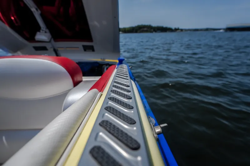 Slide: The Image of 2003 Cigarette 38' Top Gun boat interior with red and white seating on water. - 18