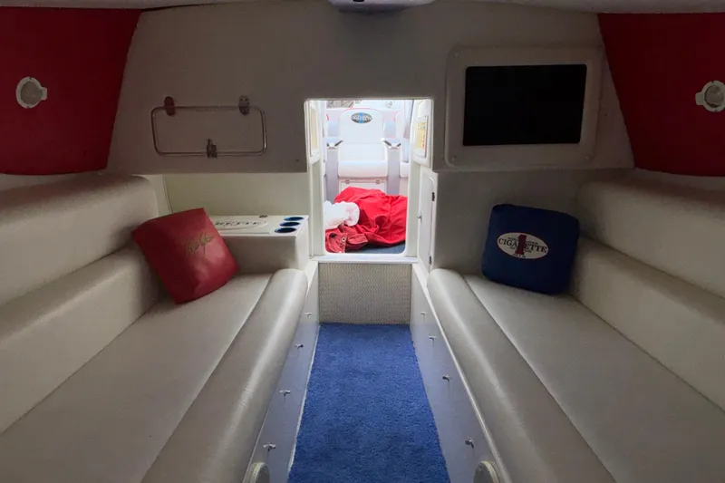 Slide: The Image of Interior of a 2003 Cigarette 38' Top Gun boat with cushioned seating and pillows. - 30