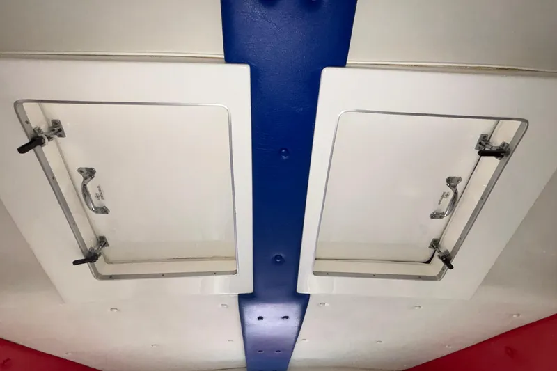 Slide: The Image of 2003 Cigarette 38' Top Gun boat interior hatches with blue and red accents. - 31