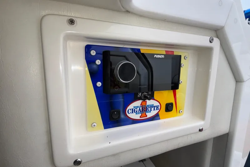 Slide: The Image of 2003 Cigarette 38' Top Gun boat dashboard with Fusion stereo system. - 33