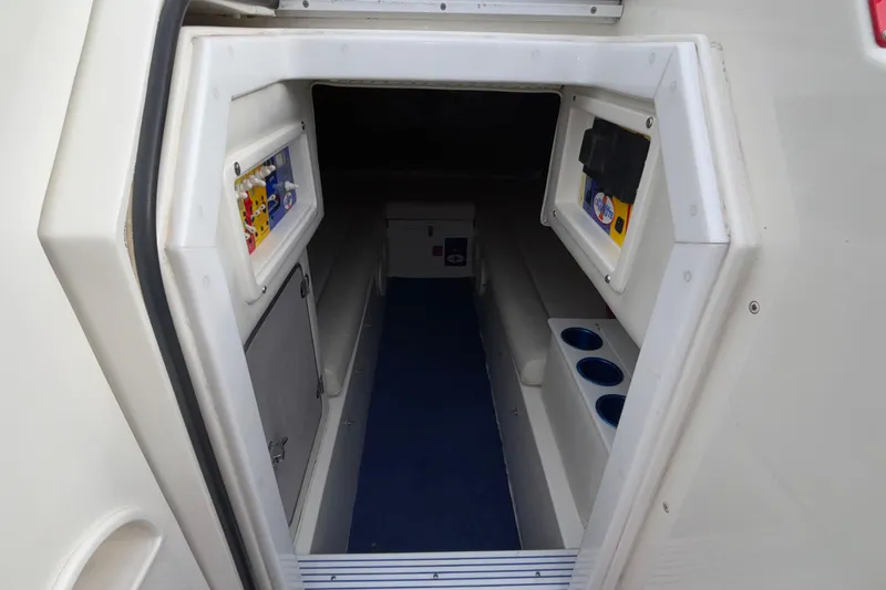 Slide: The Image of Interior cabin of 2003 Cigarette 38' Top Gun boat, featuring seating and storage compartments. - 34
