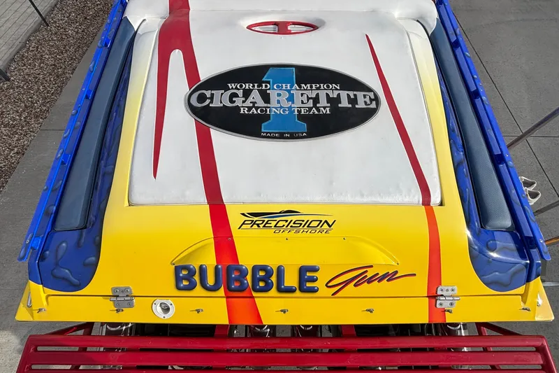 Slide: The Image of 2003 Cigarette 38' Top Gun boat with vibrant "Bubble Gun" design and racing team logo. - 37