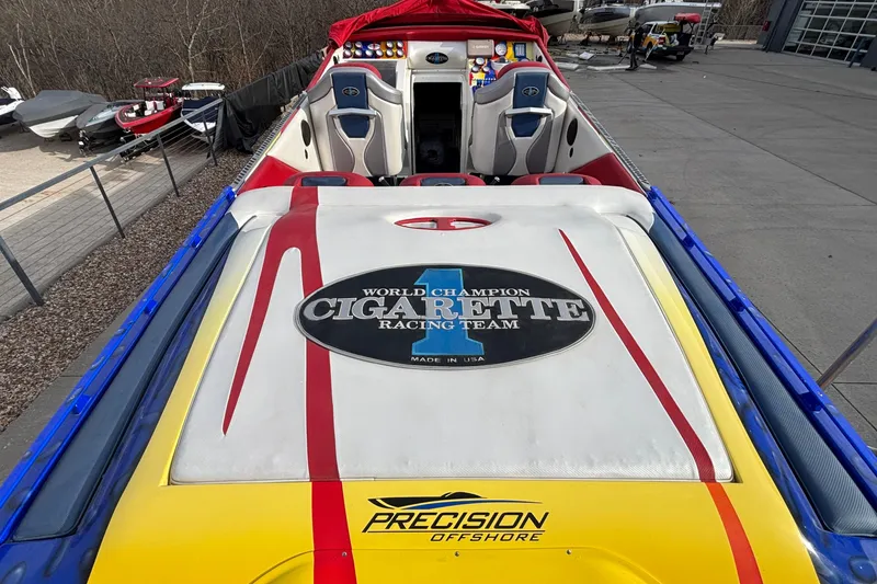 Slide: The Image of 2003 Cigarette 38' Top Gun boat with vibrant racing design and logo. - 38