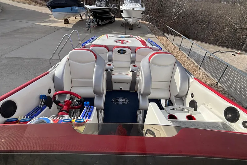 Slide: The Image of 2003 Cigarette 38' Top Gun boat with red and white interior, docked outdoors. - 42