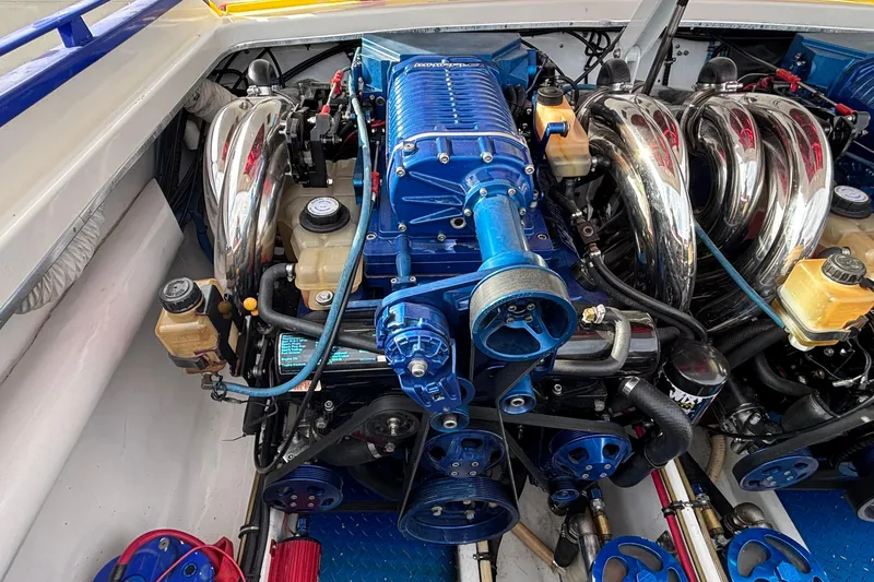 Slide: The Image of Engine of a 2003 Cigarette 38' Top Gun boat, featuring blue and chrome components. - 6