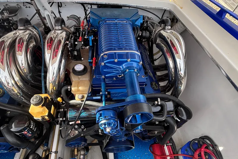 Slide: The Image of High-performance engine of a 2003 Cigarette 38' Top Gun boat, featuring chrome and blue components. - 7
