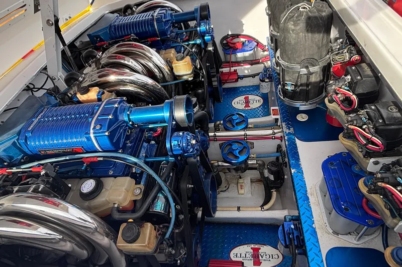 Slide: The Image of Engine compartment of a 2003 Cigarette 38' Top Gun boat, showcasing dual high-performance engines. - 8