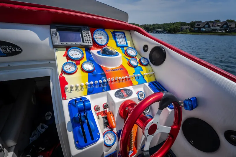 Slide: The Image of Cockpit of 2003 Cigarette 38' Top Gun boat with colorful gauges and controls. - 17
