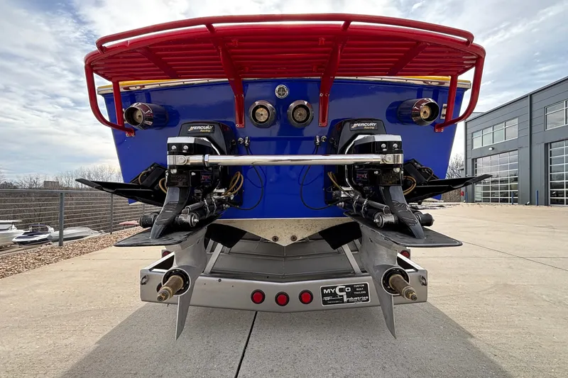 Slide: The Image of Rear view of a 2003 Cigarette 38' Top Gun boat with dual Mercury engines. - 27