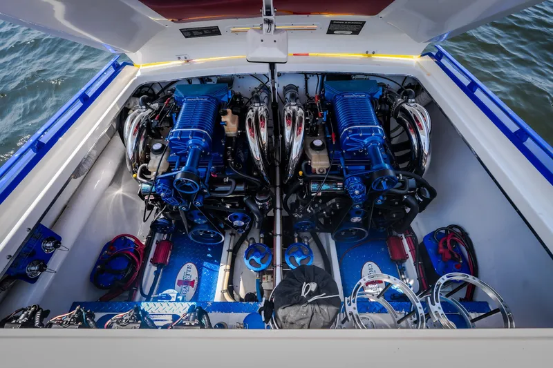 Slide: The Image of Engine compartment of a 2003 Cigarette 38' Top Gun boat with dual engines. - 19