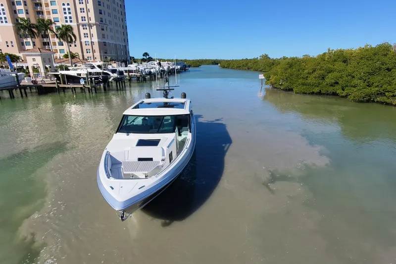 Slide: The Image of 2022 Formula 500 Super Sport Crossover yacht with luxurious seating and scenic waterfront view. - 3