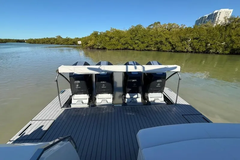 Slide: The Image of 2022 Formula 500 Super Sport Crossover yacht docked in sunny marina with palm trees. - 6