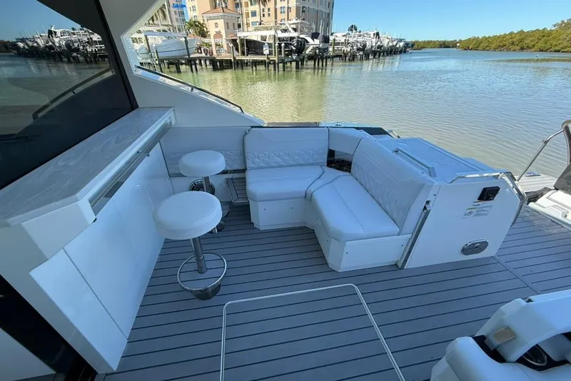 Slide: The Image of 2022 Formula 500 Super Sport Crossover boat docked in a marina with palm trees. - 7