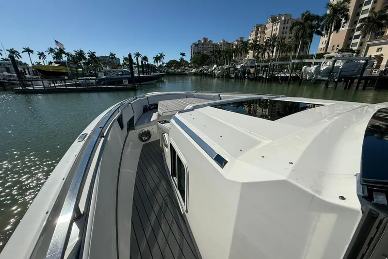 Slide: The Image of 2022 Formula 500 Super Sport Crossover boat with spacious seating and table on deck. - 8
