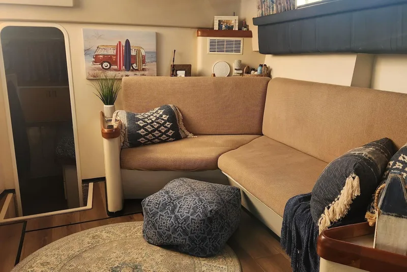 Slide: The Image of Cozy interior of 1995 Mainship 37 Motor Yacht with beige seating and nautical decor. - 4