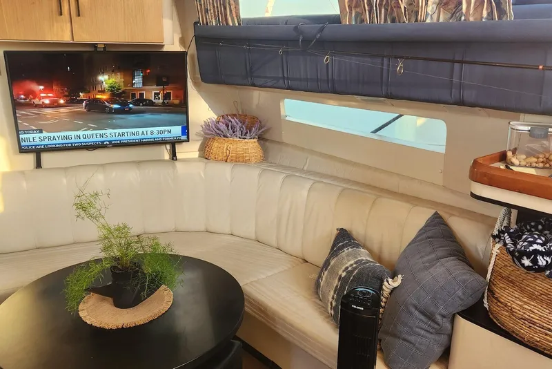 Slide: The Image of Interior of 1995 Mainship 37 Motor Yacht with cozy seating and TV. - 6