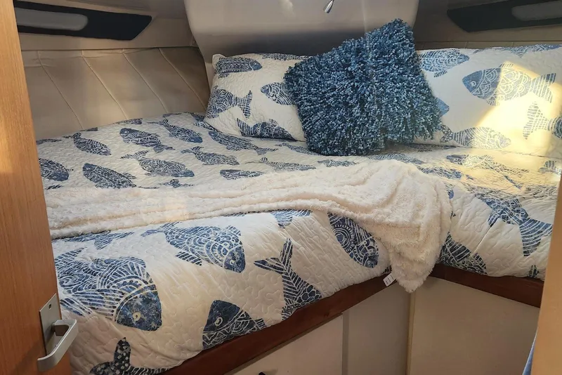 Slide: The Image of Cozy bedroom in 1995 Mainship 37 Motor Yacht with fish-themed bedding and plush pillow. - 7