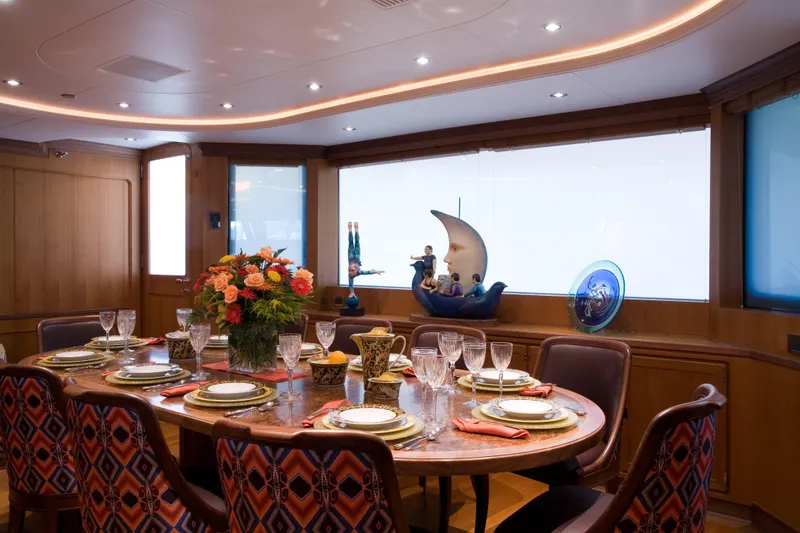 Slide: The Image of Luxurious dining area on 2007 Perini Navi 52M yacht, featuring elegant table setting and decor. - 22
