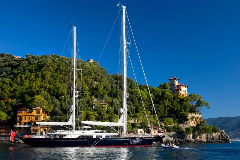 Slide: The Image of Luxurious 2007 Perini Navi 52M yacht sailing near scenic coastal villas. - 6