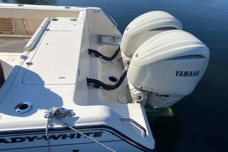 Slide: The Image of 2024 Grady-White Canyon 306 boat with dual Yamaha outboard engines on calm water. - 16