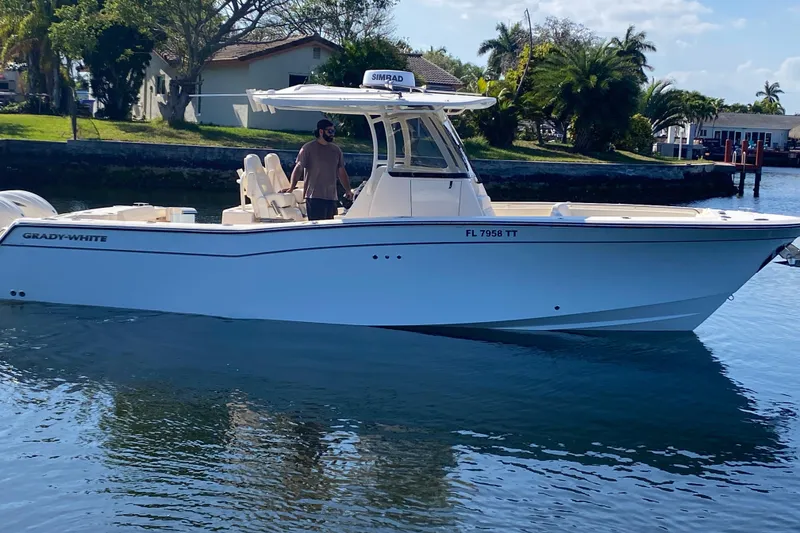 Slide: The Image of 2024 Grady-White Canyon 306 boat on calm water, side view. - 6