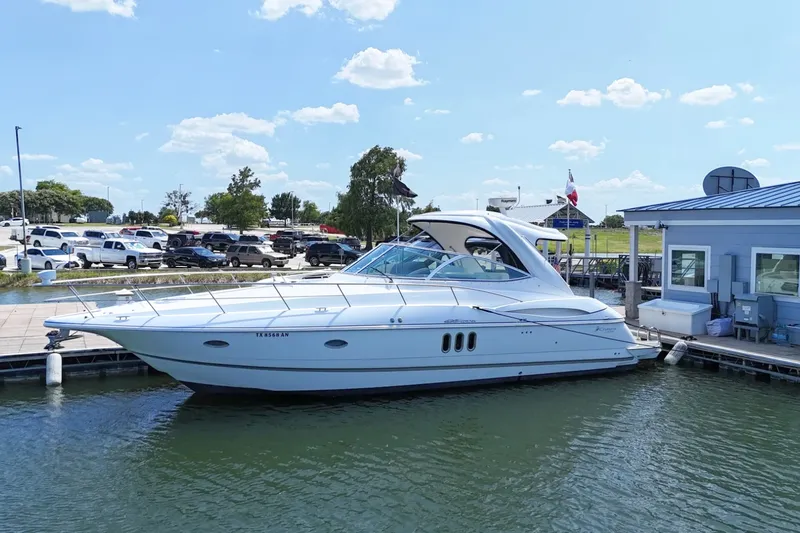 Slide: The Image of 2007 Cruisers Yachts 420 Express at dock, sleek white design, sunny day. - 0
