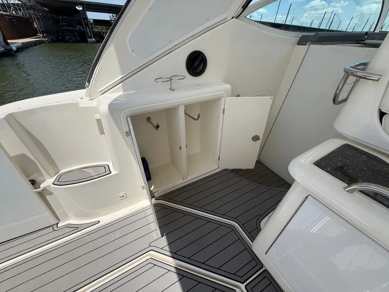 Slide: The Image of The image shows the cockpit of a 2007 Cruisers Yachts 420 Express with an open storage compartment. - 35