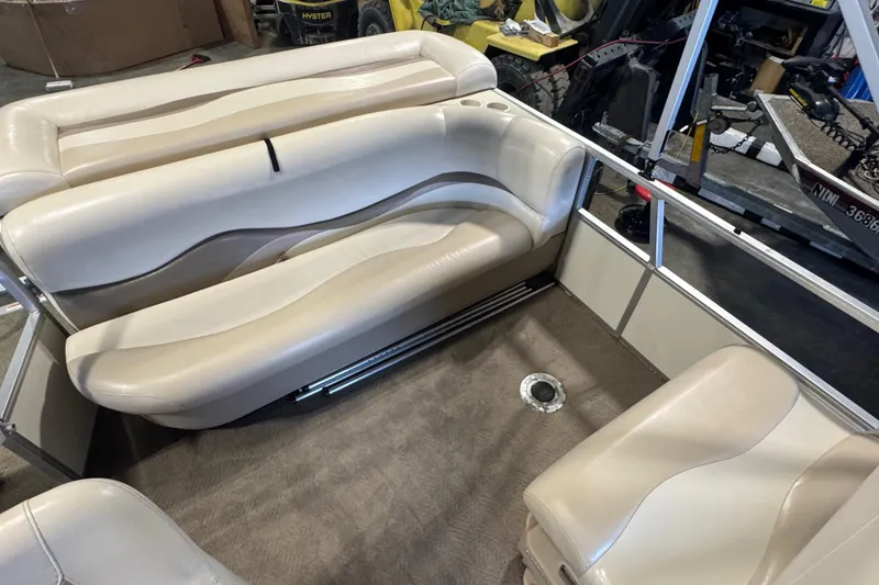 Slide: The Image of 2007 Sun Tracker Party Barge 18 interior with beige seating and carpeted floor. - 16