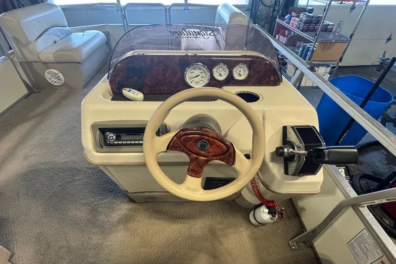 Slide: The Image of 2007 Sun Tracker Party Barge 18 Signature Series helm with steering wheel and controls. - 19