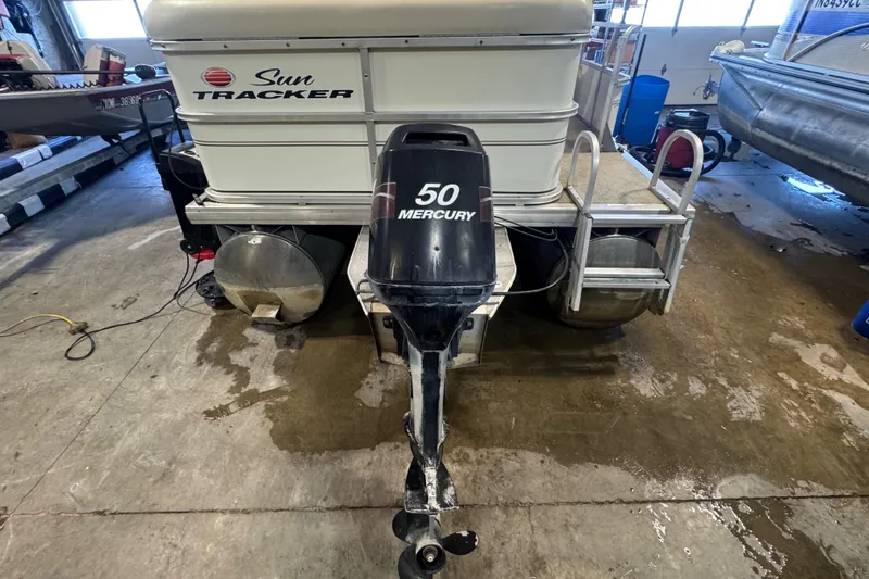Slide: The Image of 2007 Sun Tracker Party Barge 18 with Mercury 50 engine in a garage setting. - 4