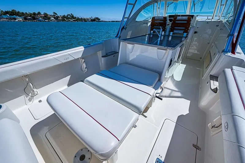 Slide: The Image of 2006 Pursuit 345 Drummond Runner LS boat interior with white seating and ocean view. - 11