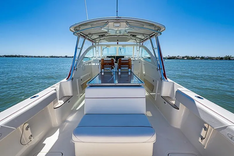 Slide: The Image of 2006 Pursuit 345 Drummond Runner LS boat interior on calm water, clear sky. - 12