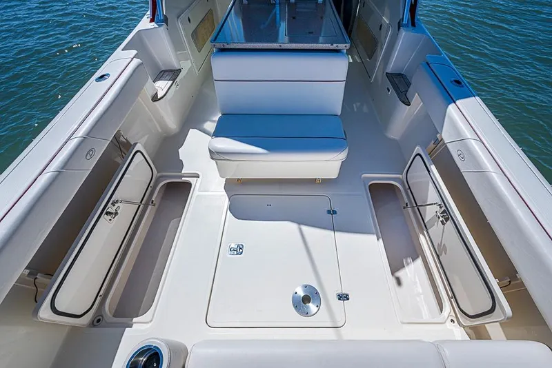 Slide: The Image of 2006 Pursuit 345 Drummond Runner LS boat interior with open storage compartments. - 13