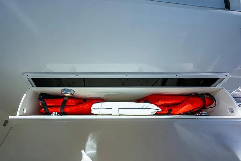 Slide: The Image of Storage compartment with life jackets on a 2006 Pursuit 345 Drummond Runner LS boat. - 15