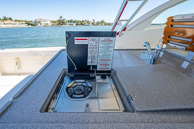Slide: The Image of 2006 Pursuit 345 Drummond Runner LS boat with outdoor stove and sink, ocean view. - 16