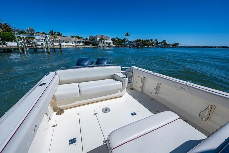 Slide: The Image of 2006 Pursuit 345 Drummond Runner LS boat on calm waters, featuring spacious seating. - 19