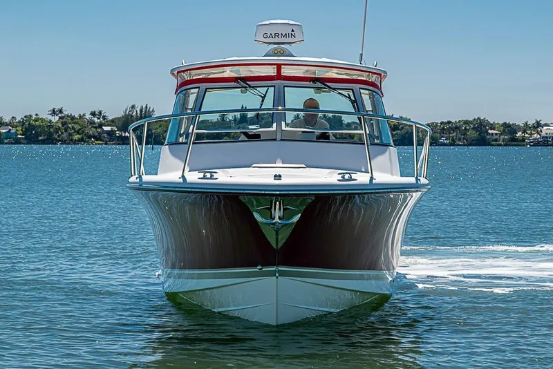 Slide: The Image of 2006 Pursuit 345 Drummond Runner LS boat cruising on a sunny day. - 2