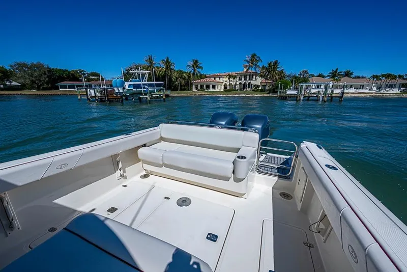 Slide: The Image of 2006 Pursuit 345 Drummond Runner LS boat on water, with scenic waterfront view. - 20