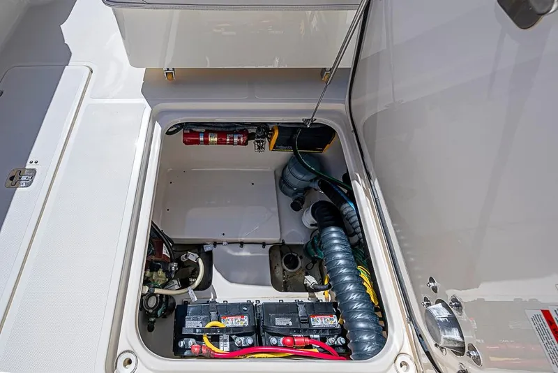 Slide: The Image of 2006 Pursuit 345 Drummond Runner LS boat compartment with batteries and fire extinguisher. - 21