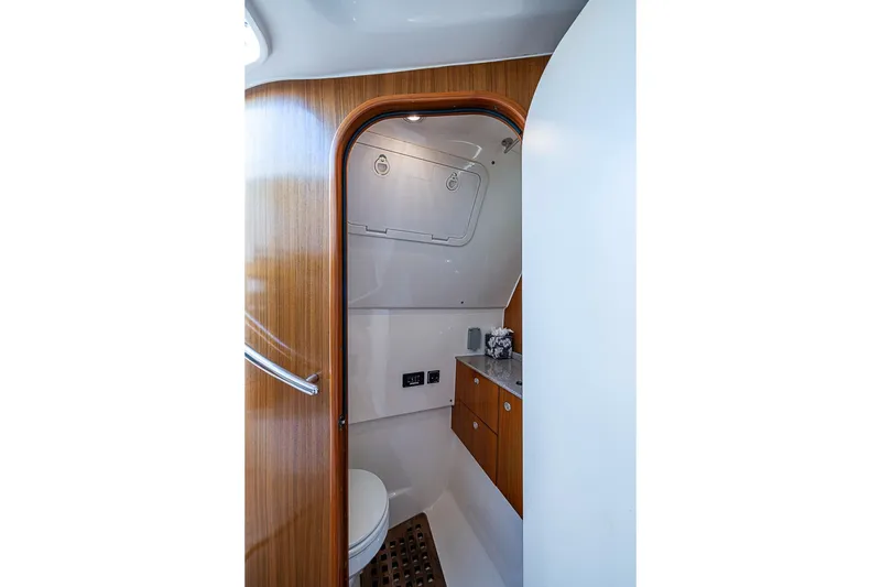 Slide: The Image of Interior of 2006 Pursuit 345 Drummond Runner LS boat bathroom with wood accents. - 25