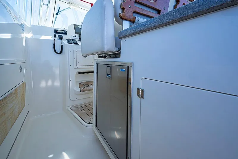 Slide: The Image of Interior of 2006 Pursuit 345 Drummond Runner LS boat with seating and storage. - 28