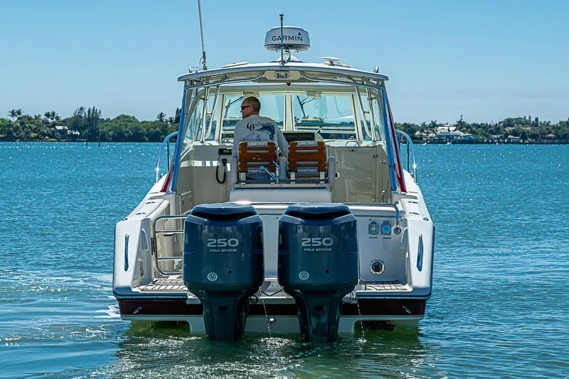 Slide: The Image of 2006 Pursuit 345 Drummond Runner LS boat on water, twin 250 engines, sunny day. - 3