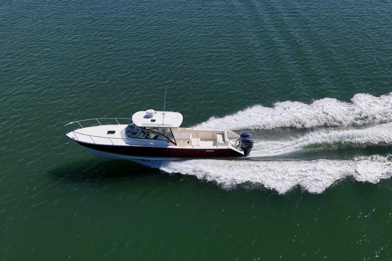 Slide: The Image of 2006 Pursuit 345 Drummond Runner LS cruising on open water, aerial view. - 31